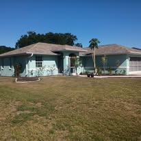 Exterior house after painting by AMG Painting — fresh teal finish