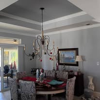 Dining room with painted tray ceiling and gray walls
